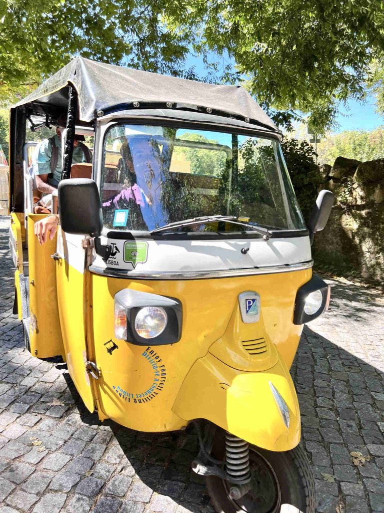 A colorful and popular tuk-tuk, a common mode of transportation for tourists exploring the charming streets of Sintra, Portugal