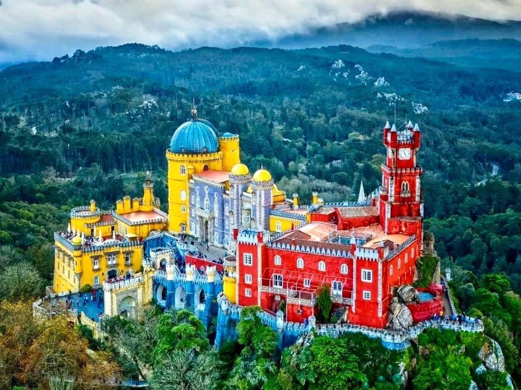 Pena Palace, a colorful fairytale castle, as seen from a distance in Sintra, Portugal